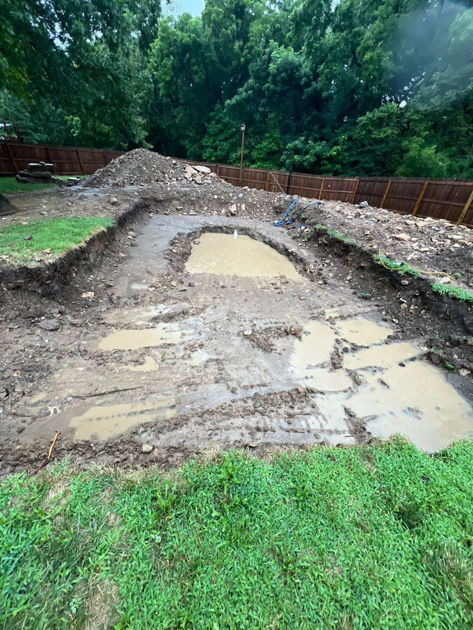 muddy excavation site for a swimming pool