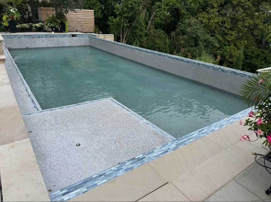 rectangular swimming pool with light blue water