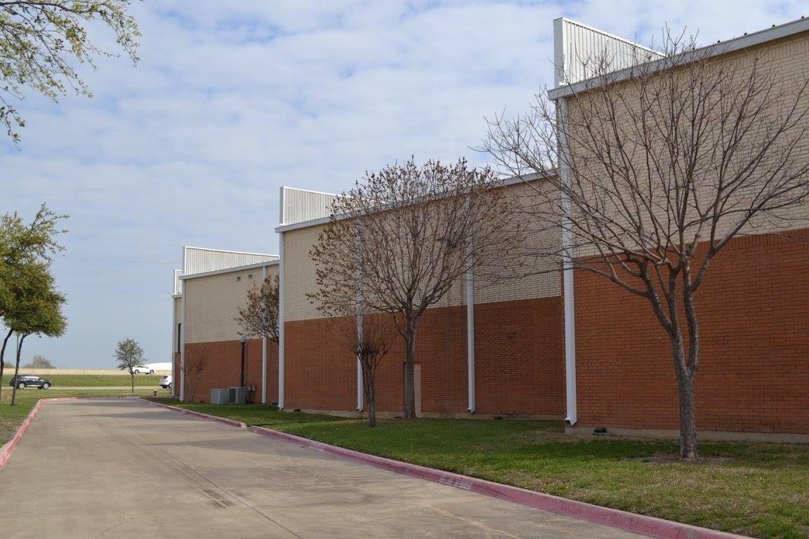 A row of buildings with trees in front of them