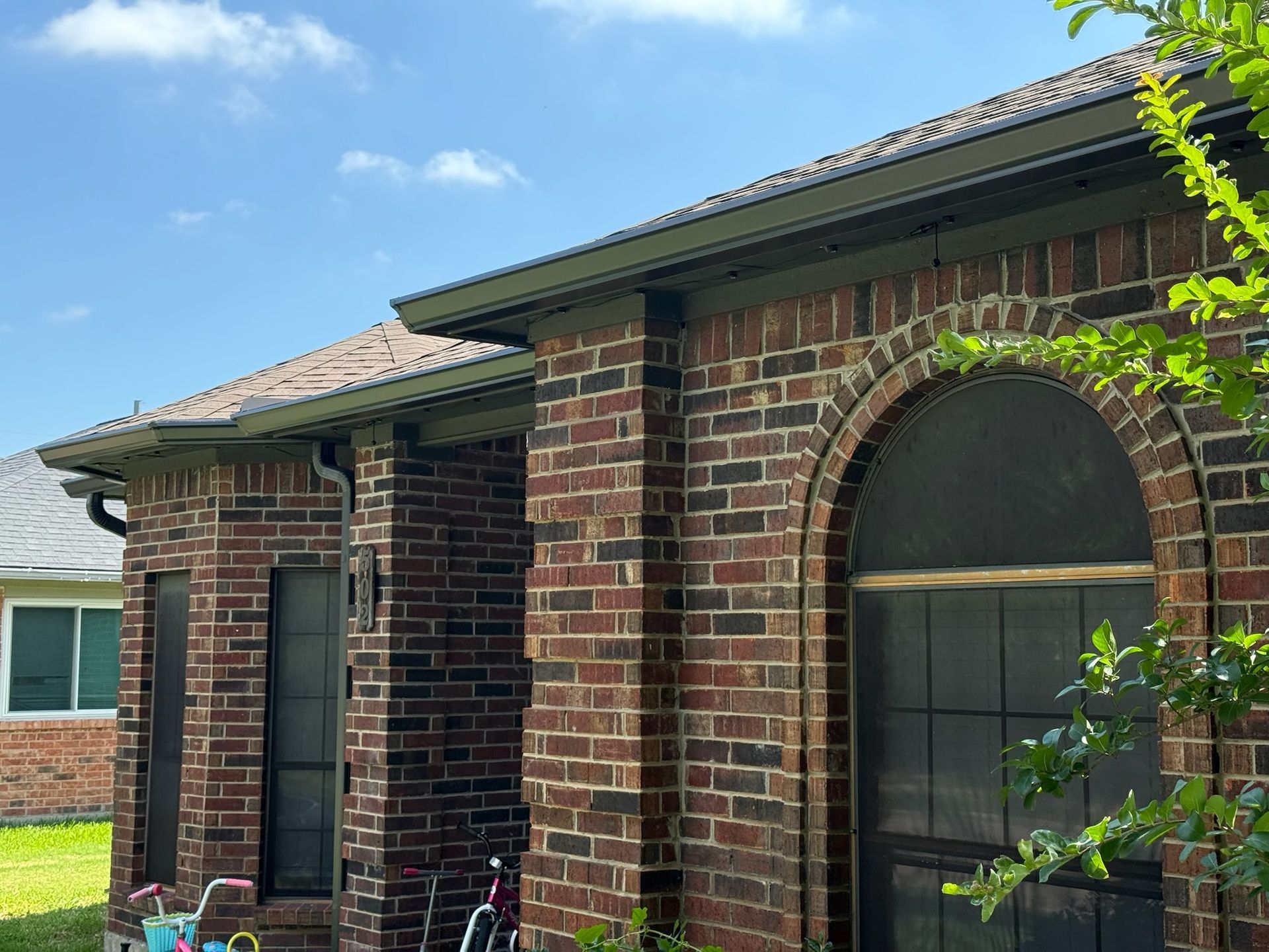 A brick house with a bicycle parked in front of it
