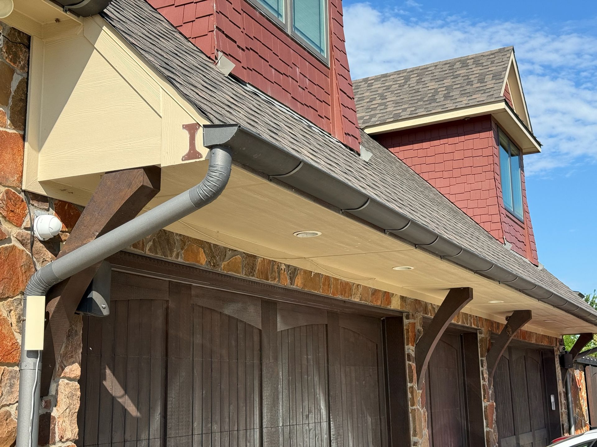 A house with a gutter on the side of it