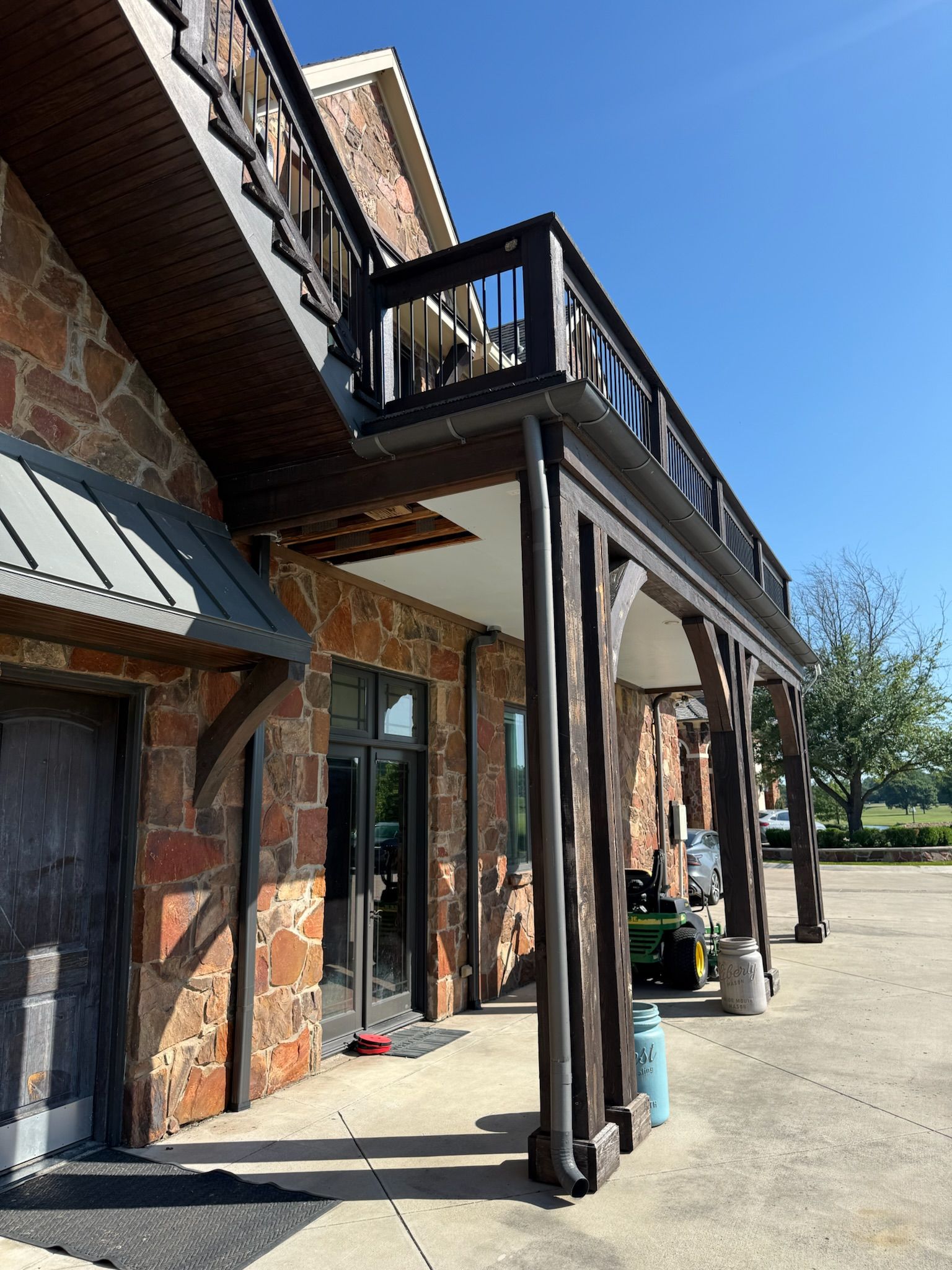 A large stone building with a balcony and stairs