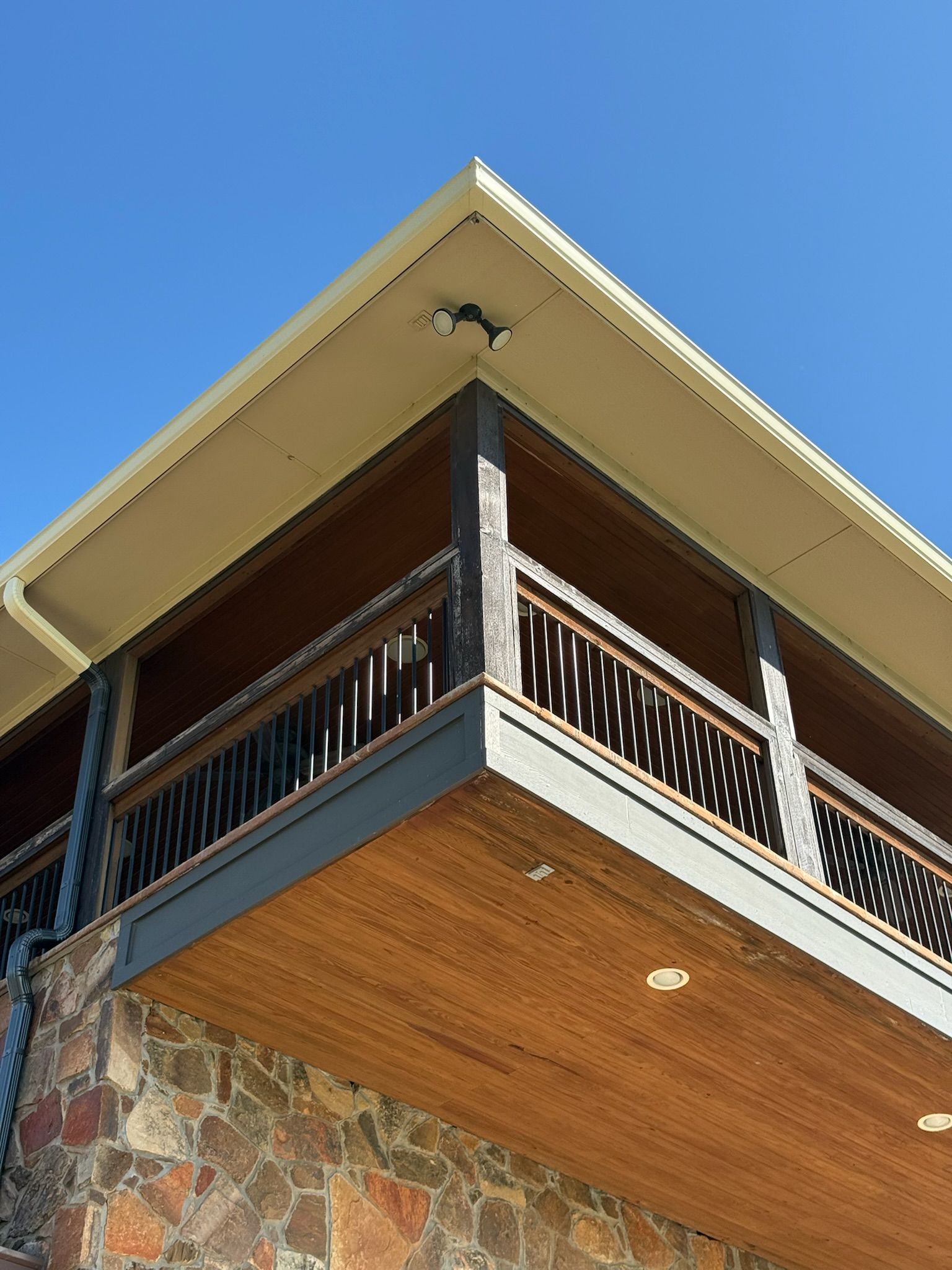 A balcony on the side of a building with a blue sky in the background