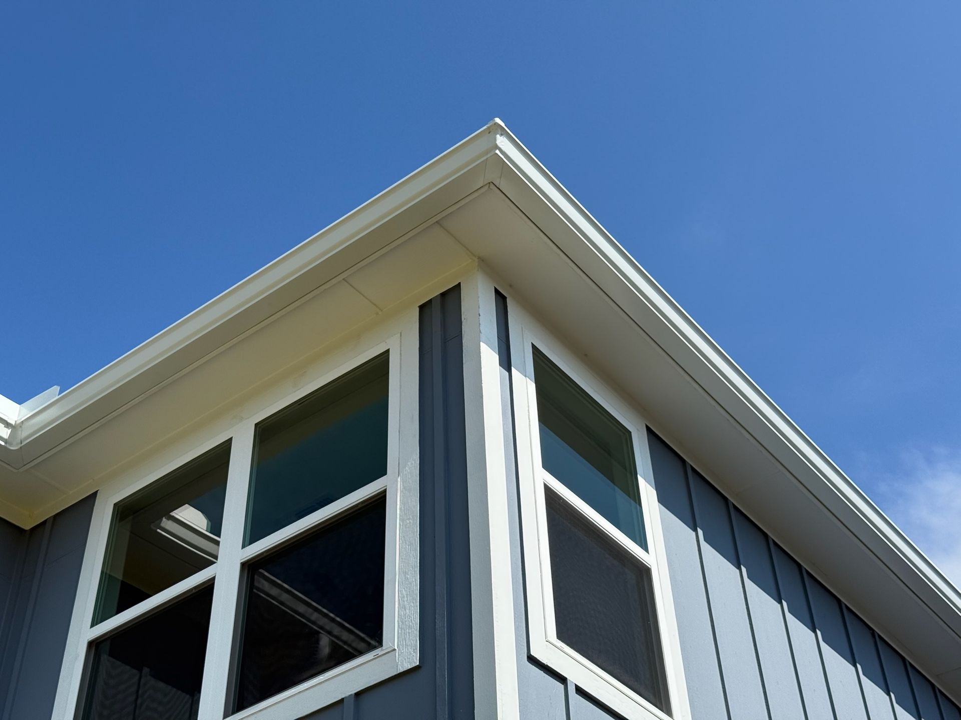 The corner of a house with a blue sky in the background