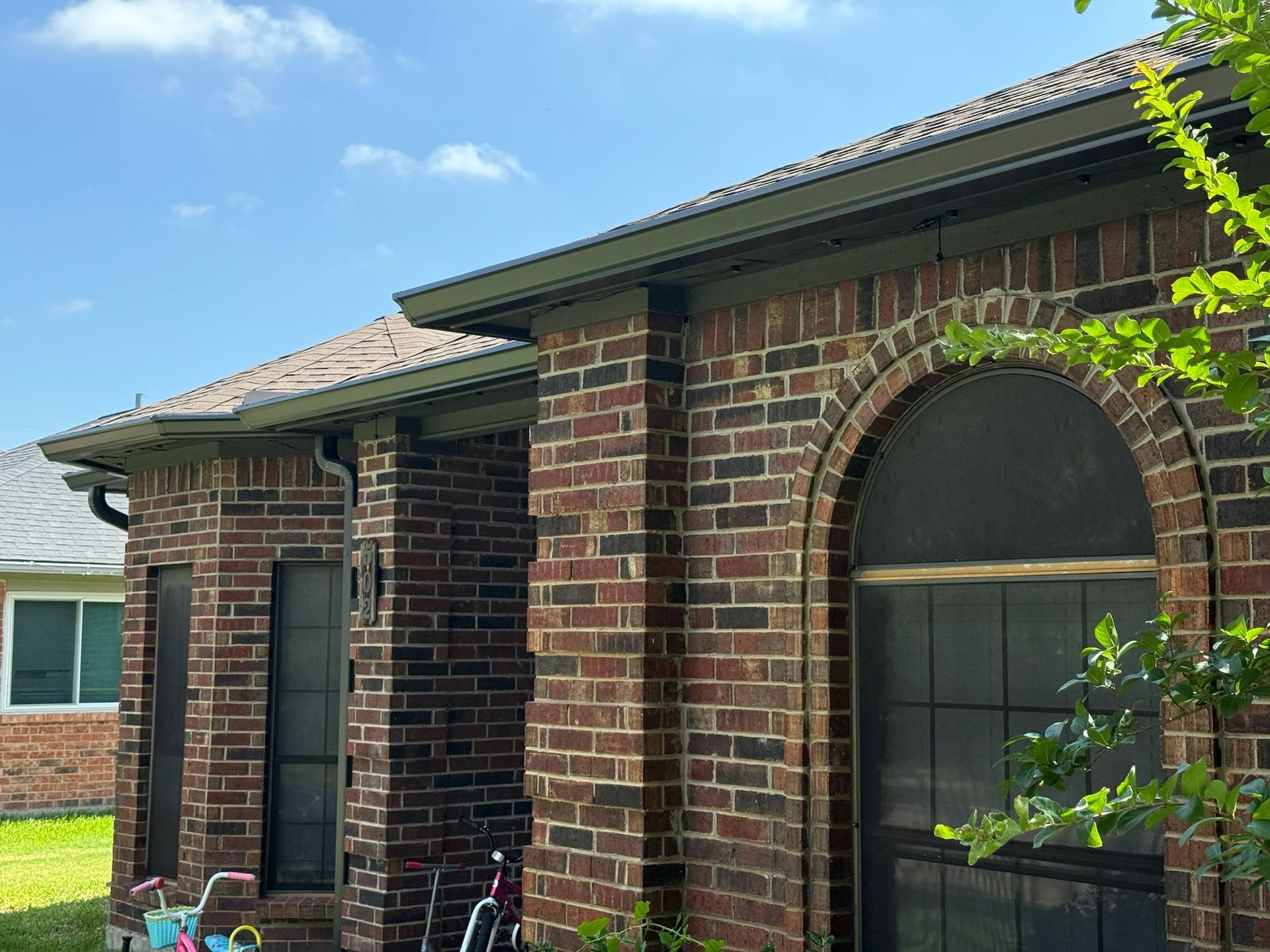 A brick house with a bicycle parked in front of it