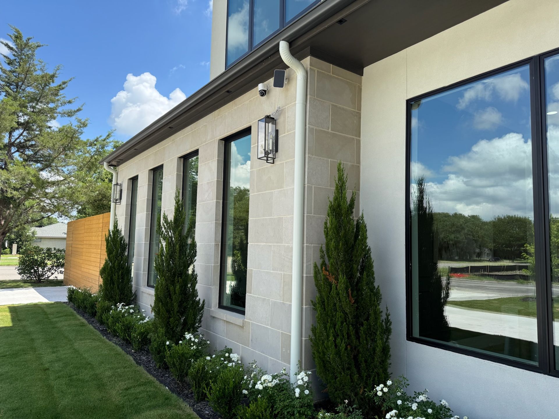 A house with a lot of windows and a gutter on the side of it.