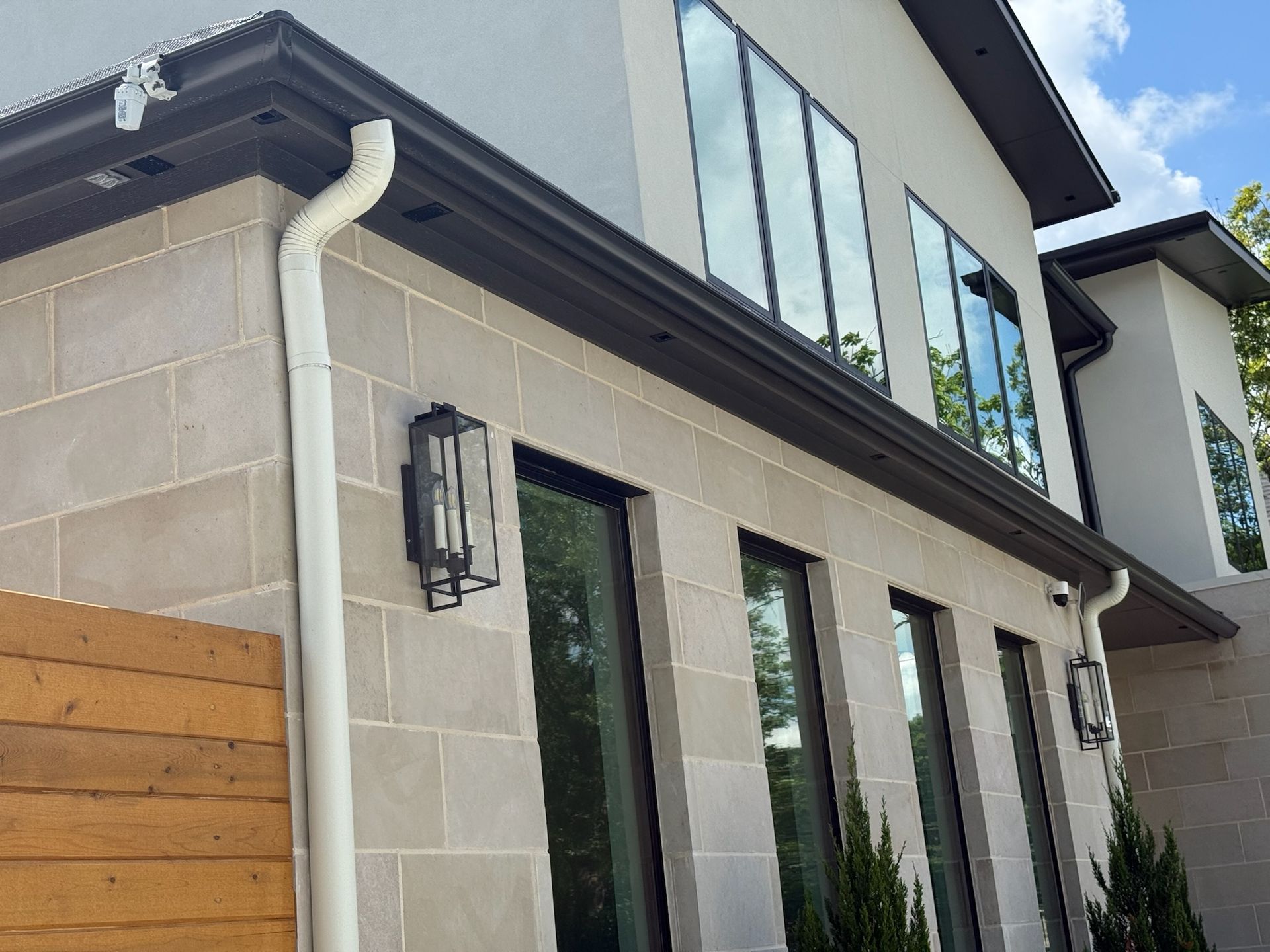 A house with a lot of windows and a gutter on the side of it.