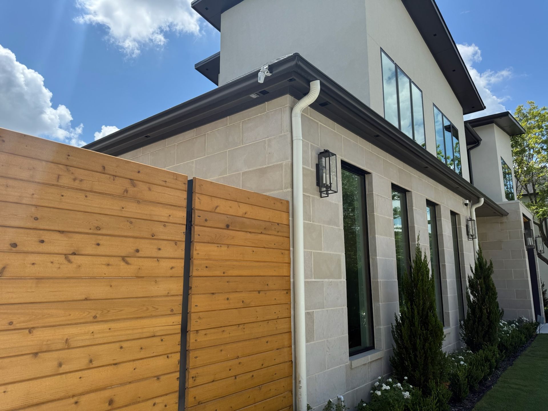 A white house with a wooden fence in front of it.