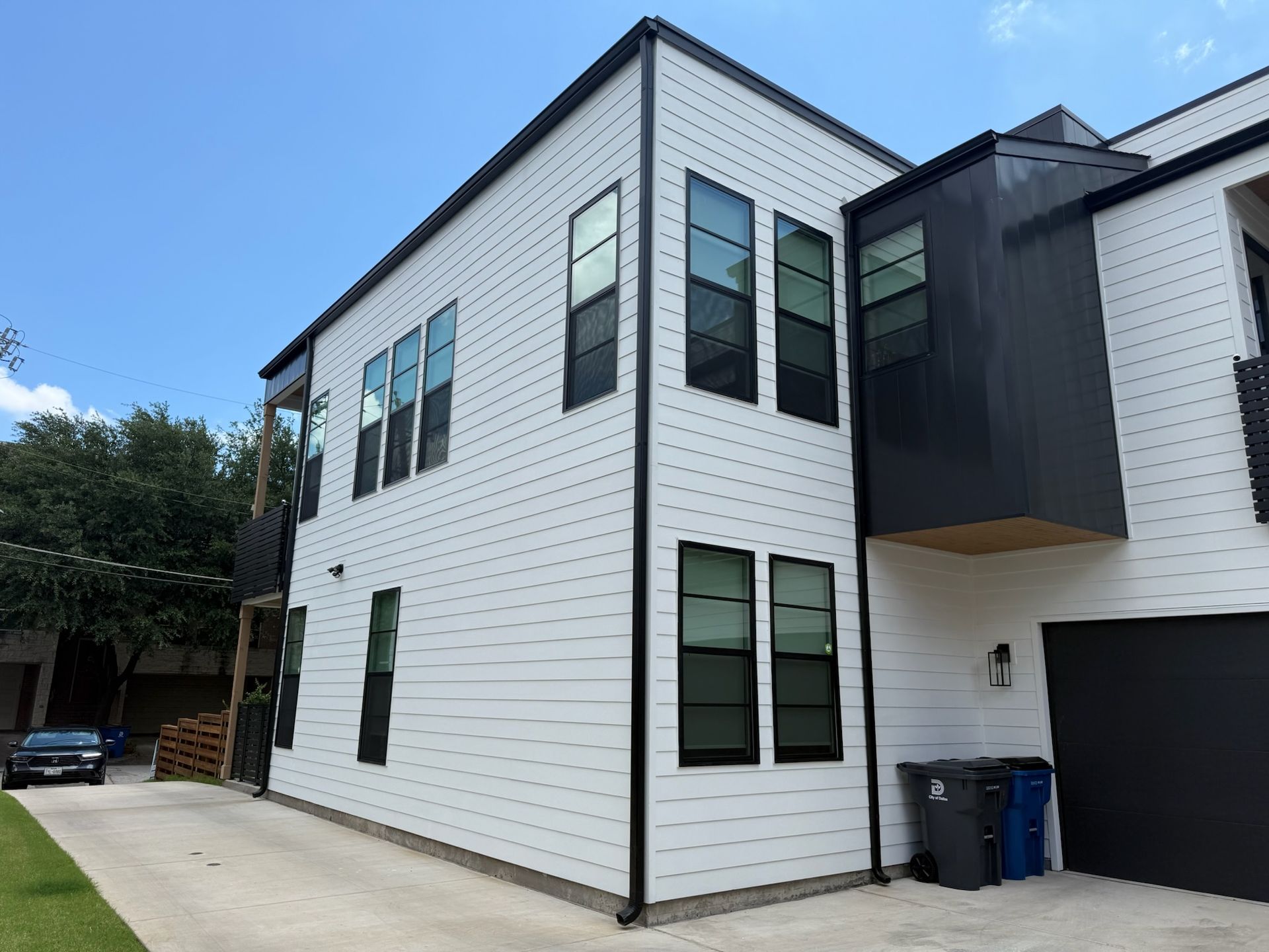 A white house with black trim and a lot of windows