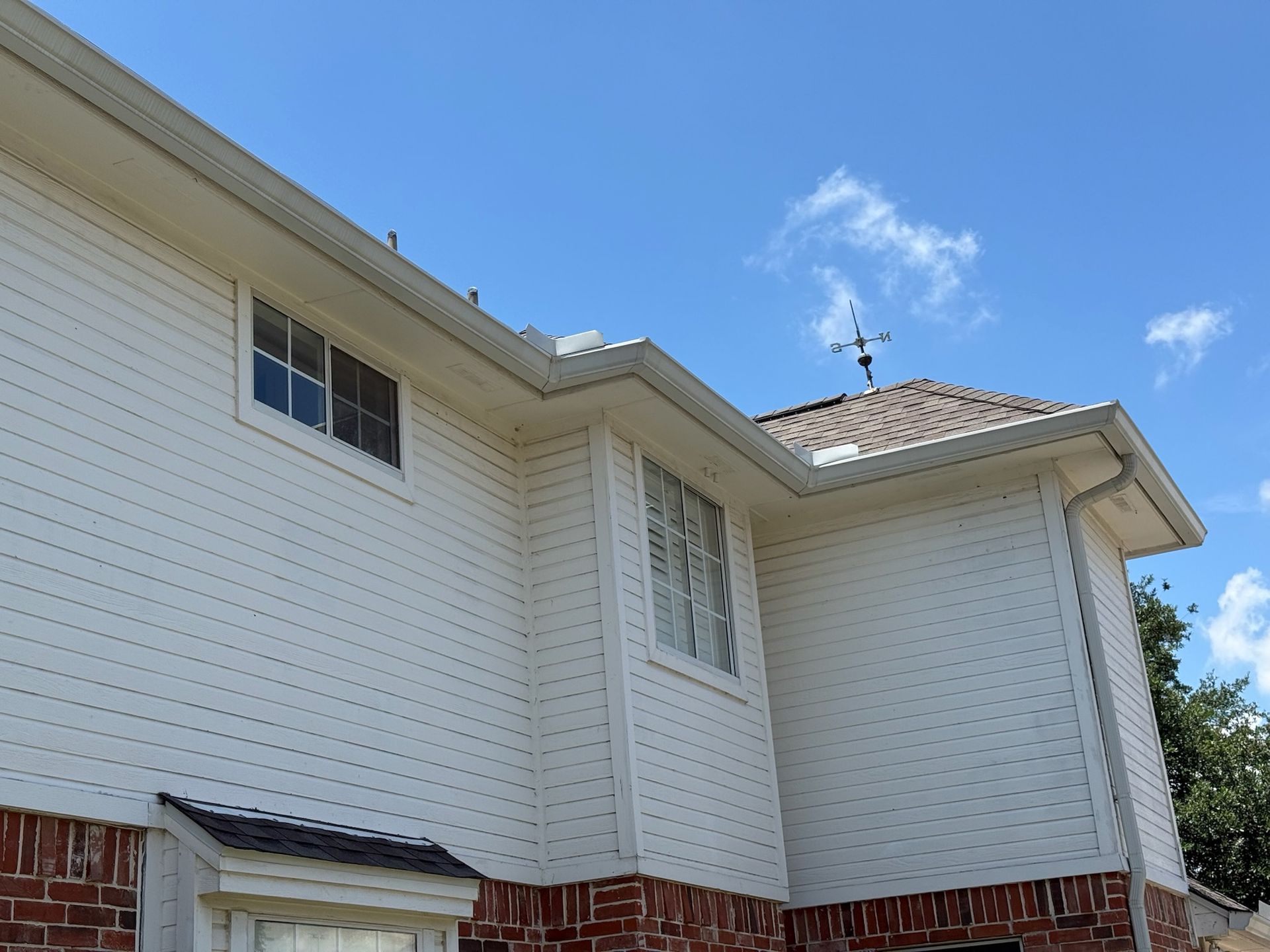 A white house with a blue sky in the background