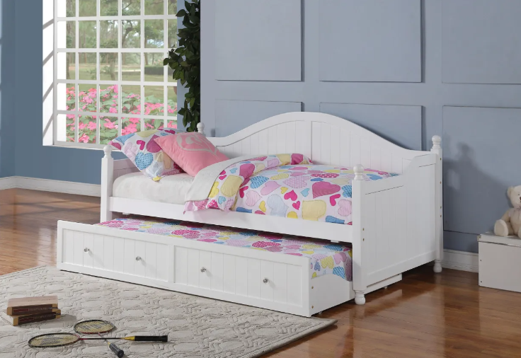 A white day bed with a drawer underneath it