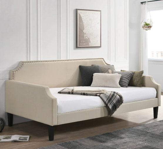 A day bed with pillows and a blanket on it