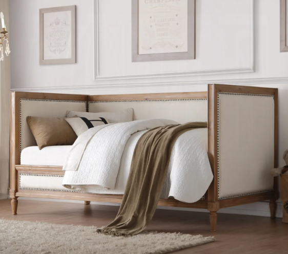 A bed with a brown blanket on it in a bedroom