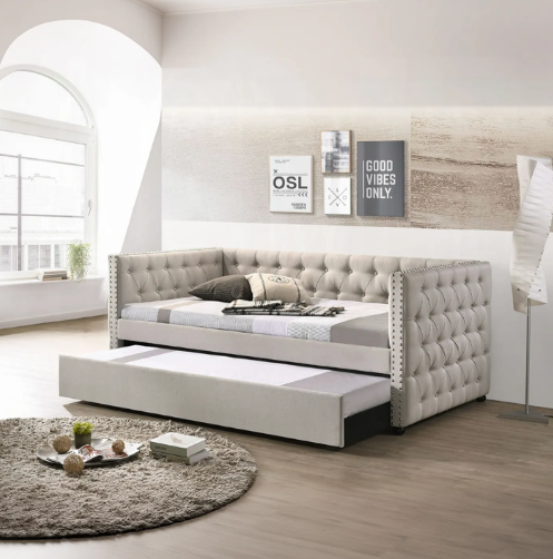 A day bed with a pull out bed underneath it in a living room.