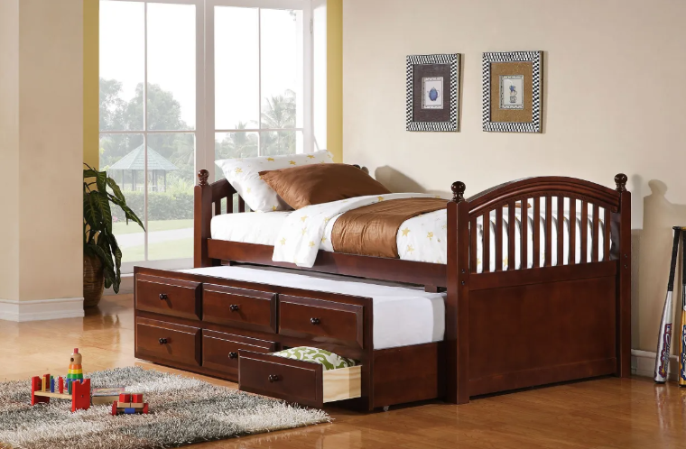 A wooden day bed with drawers underneath it