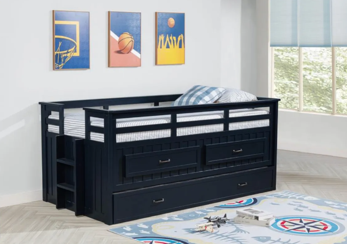 A blue bunk bed with drawers underneath it in a room.