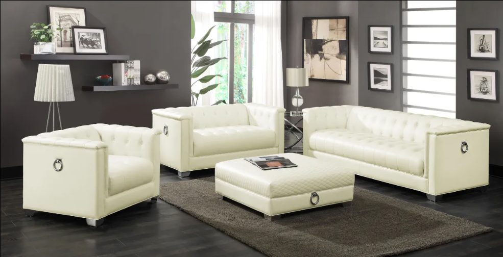 A living room with white furniture and a rug