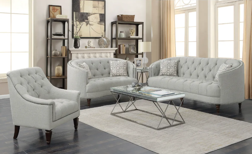A living room with a couch , chair , coffee table and rug.