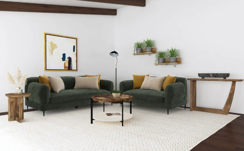 A living room with two green couches and a coffee table.