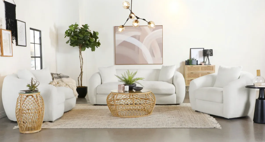A living room filled with white furniture and a coffee table.