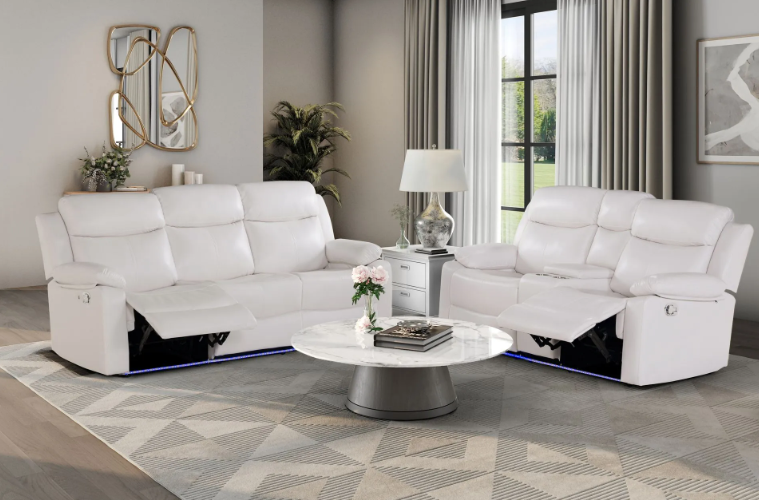 A living room with two white couches and a coffee table.