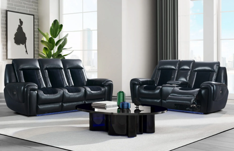 A living room with two black leather reclining couches and a black coffee table.