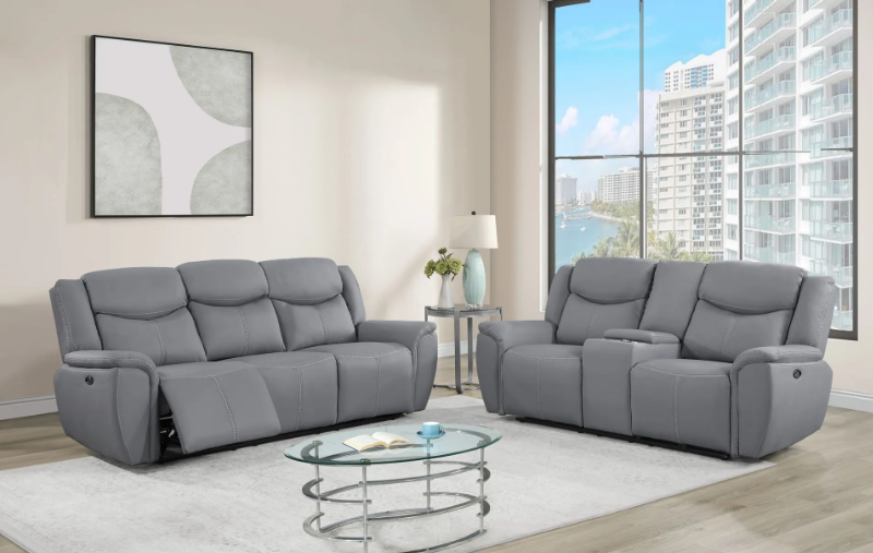 A living room with two grey couches and a glass coffee table.