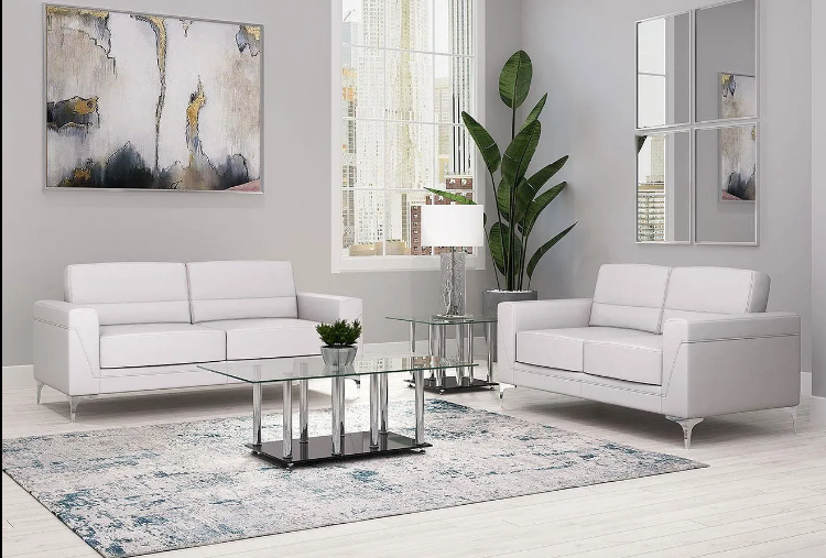 A living room with two white couches and a coffee table
