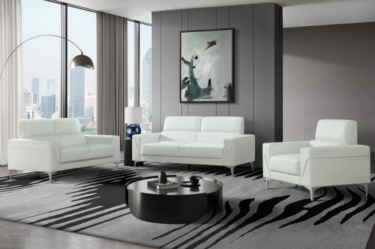 A living room with white furniture and a black coffee table