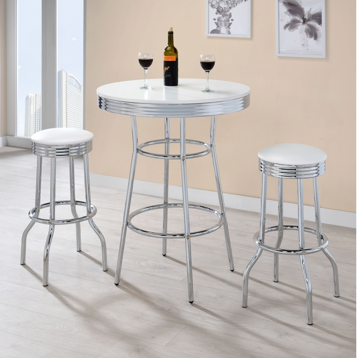 A table with two stools and a bottle of wine on it