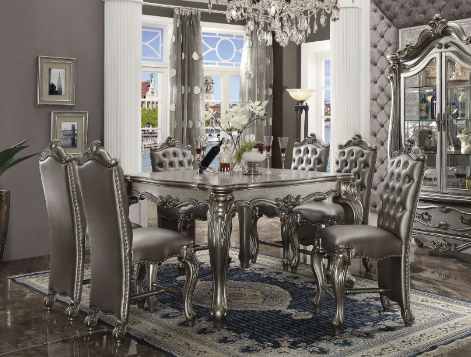 A dining room with a table and chairs and a chandelier.