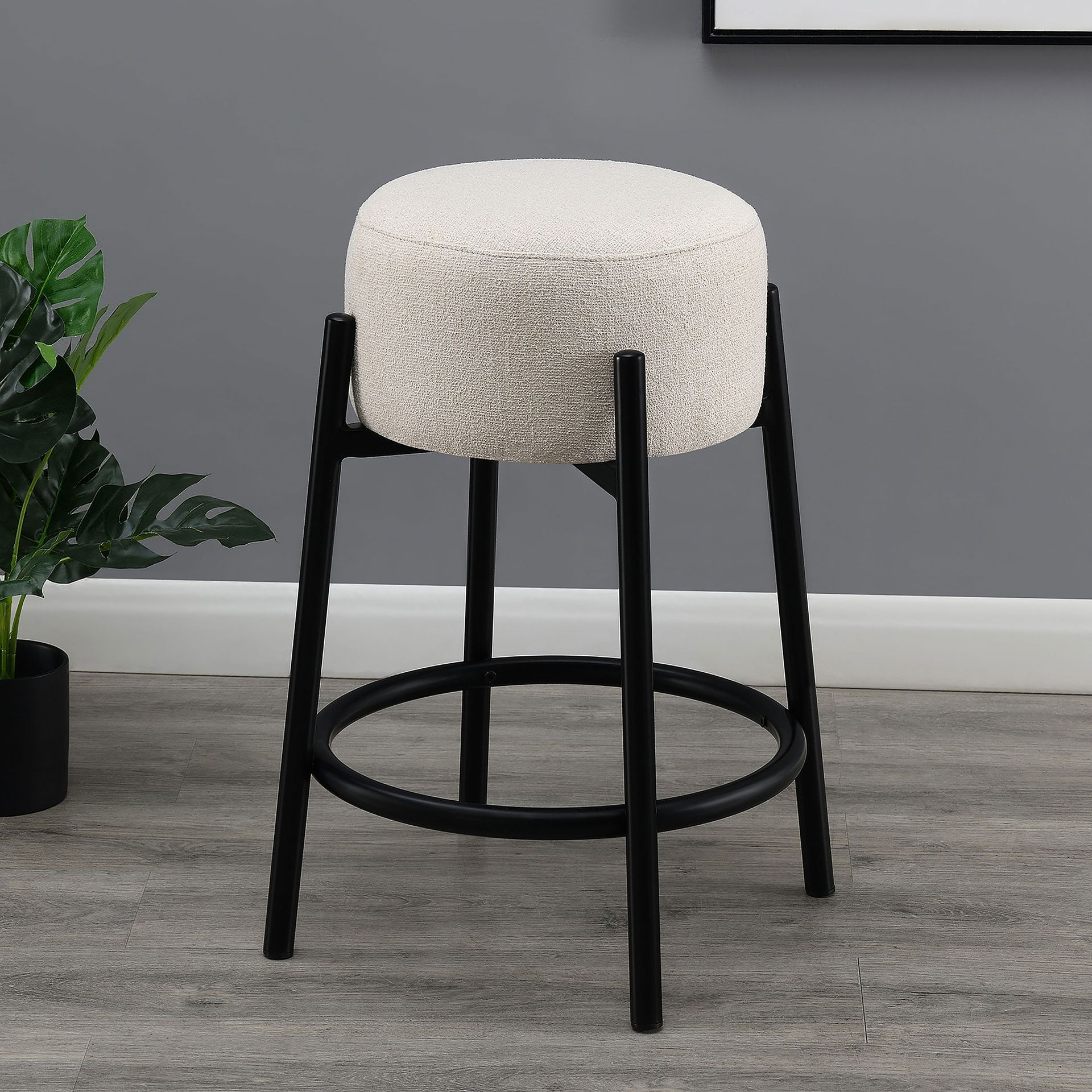 A bar stool with a white cushion and black legs
