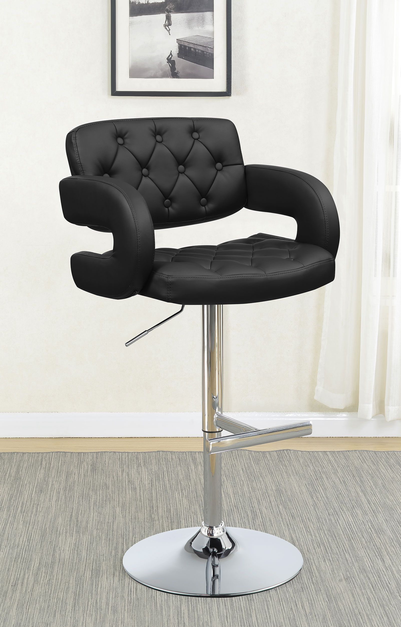 A black bar stool is sitting on a rug in a living room.