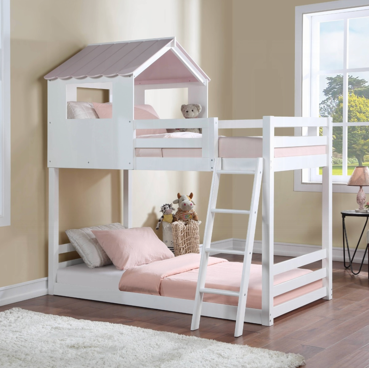 A bunk bed in the shape of a house with a pink roof