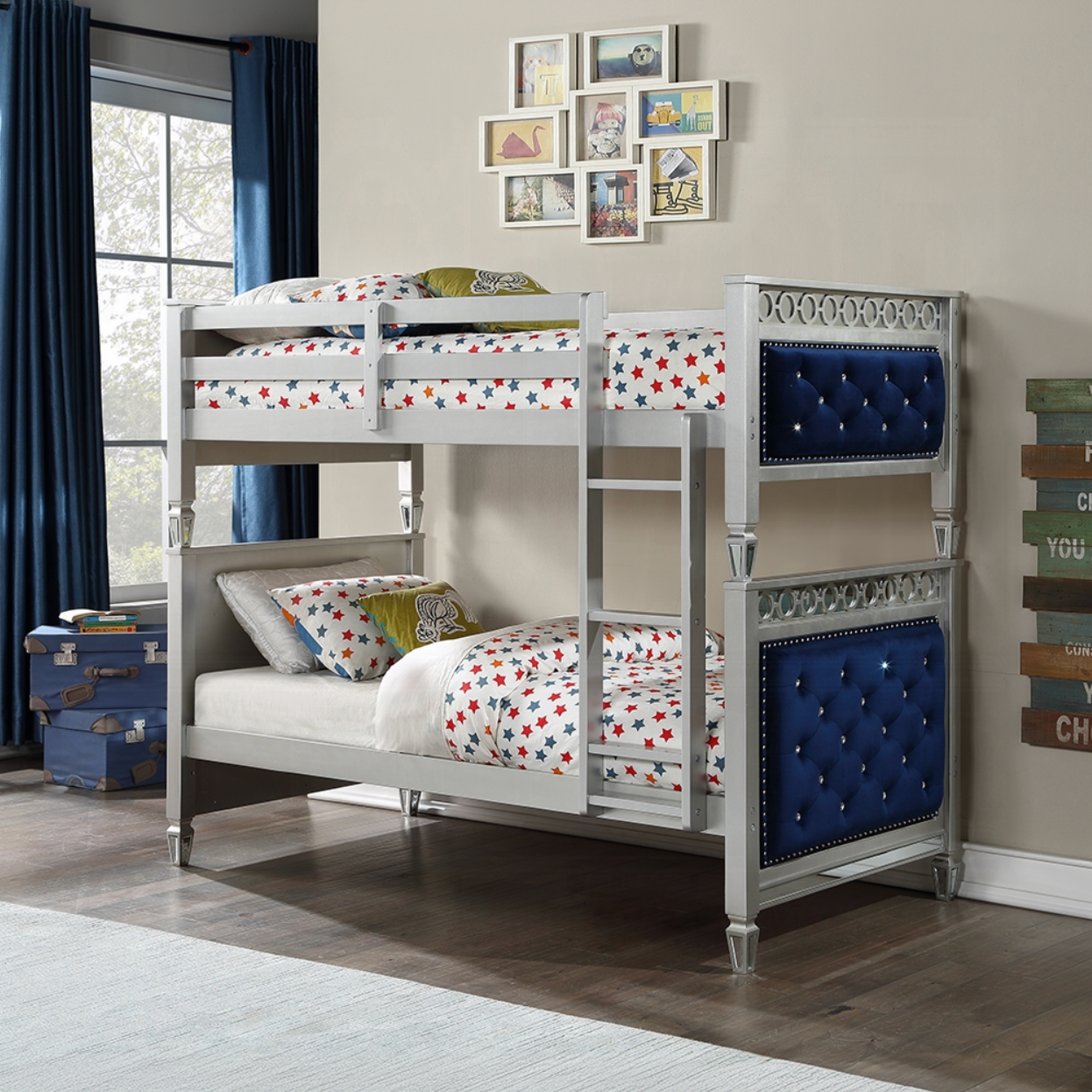 A bunk bed is sitting in a room next to a window.