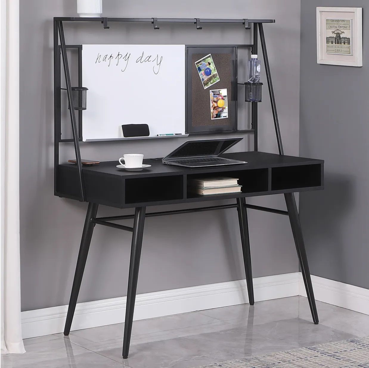 A black desk with a white board that says happy day