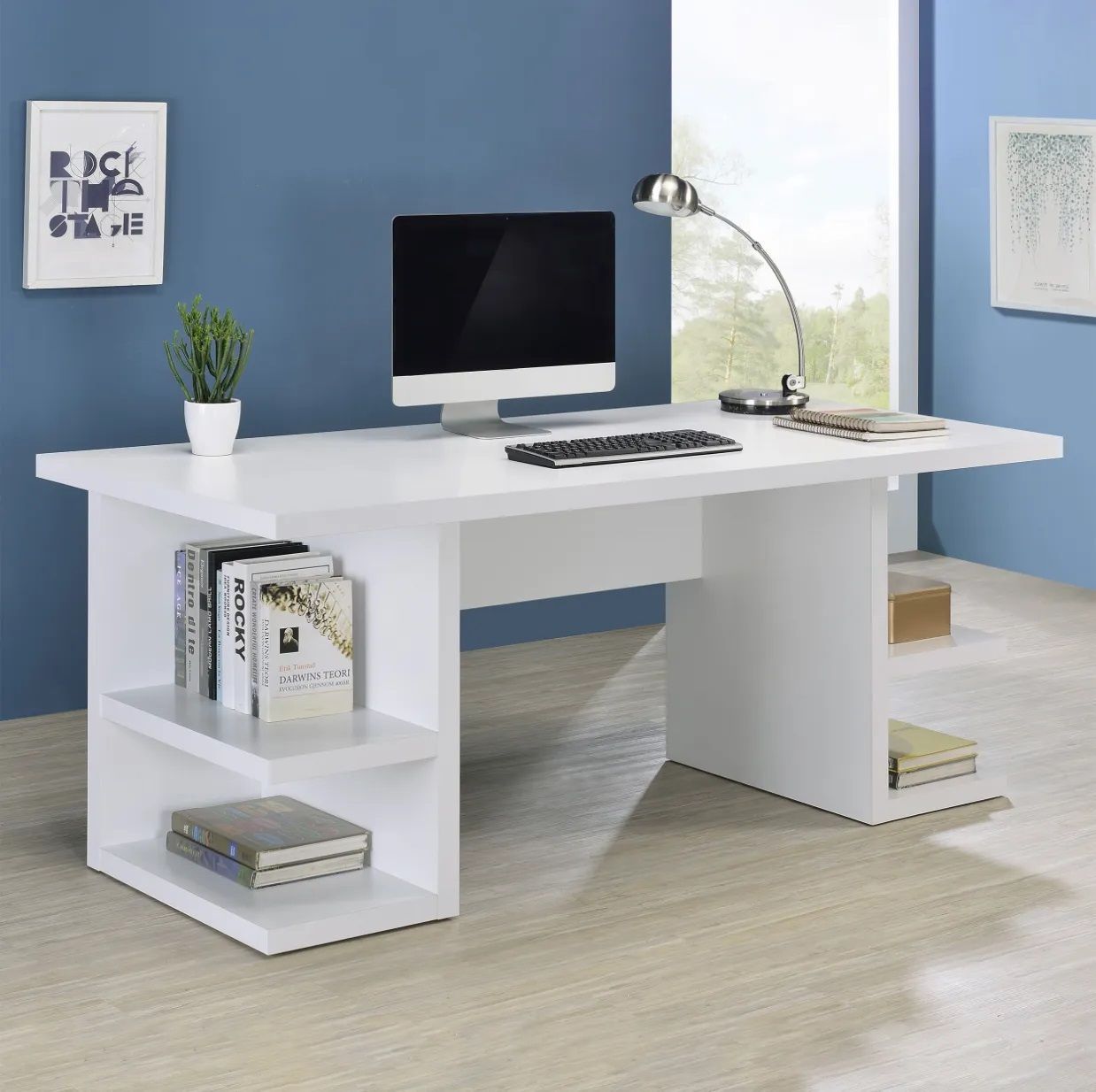 A white desk with a computer and books on it