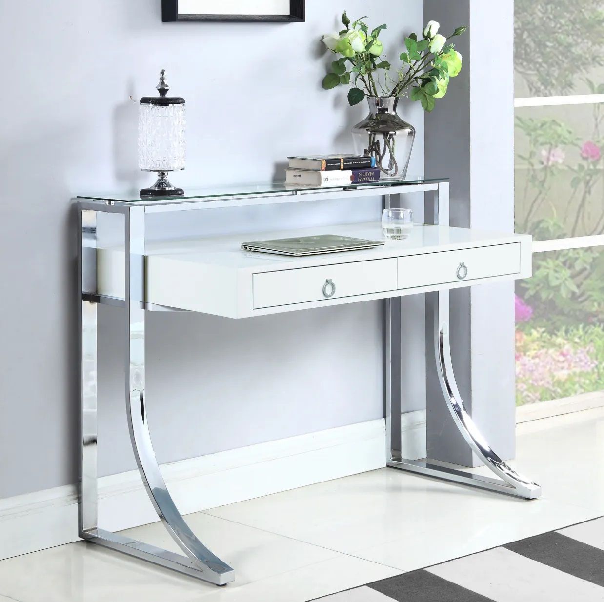 A white and chrome desk with a vase of flowers on top