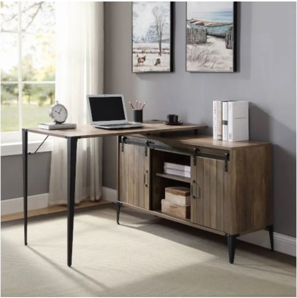 A wooden desk with a laptop on it in a room