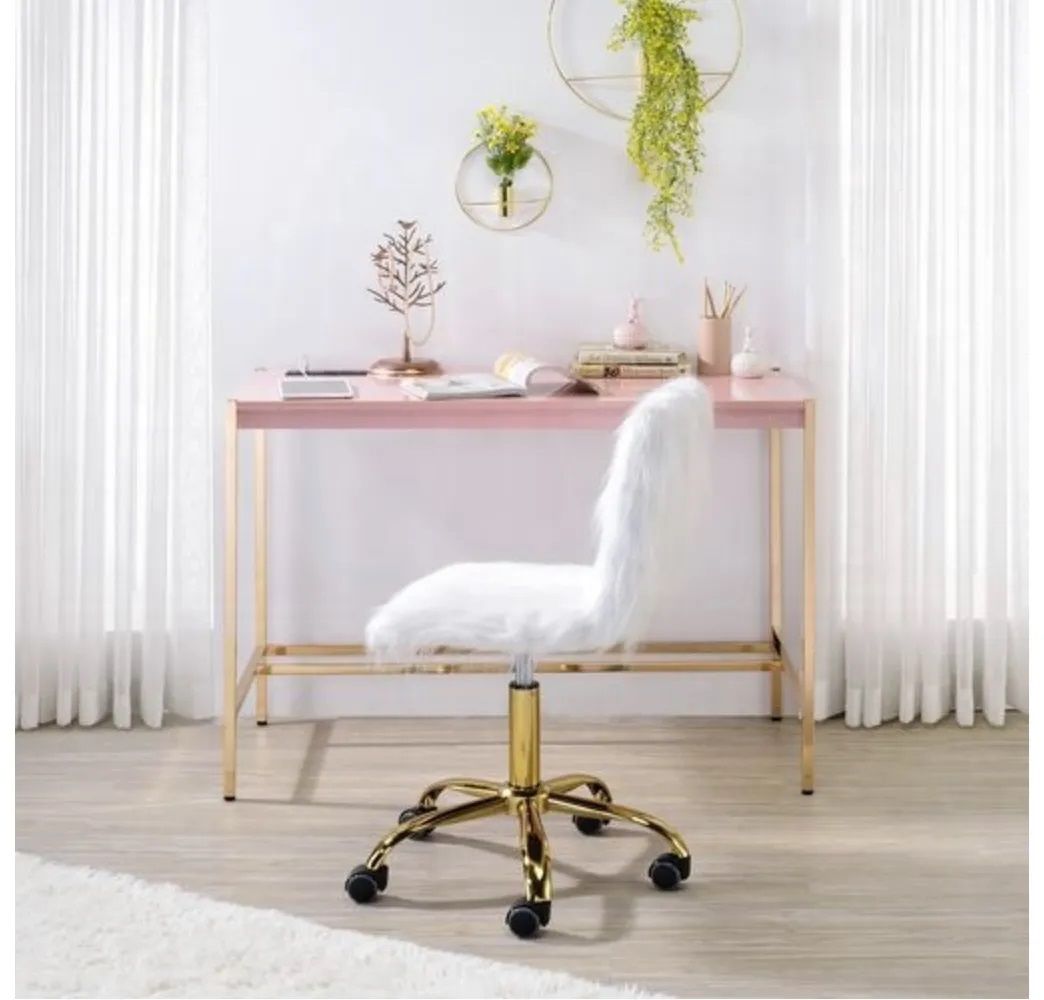 A white chair is sitting in front of a pink desk.