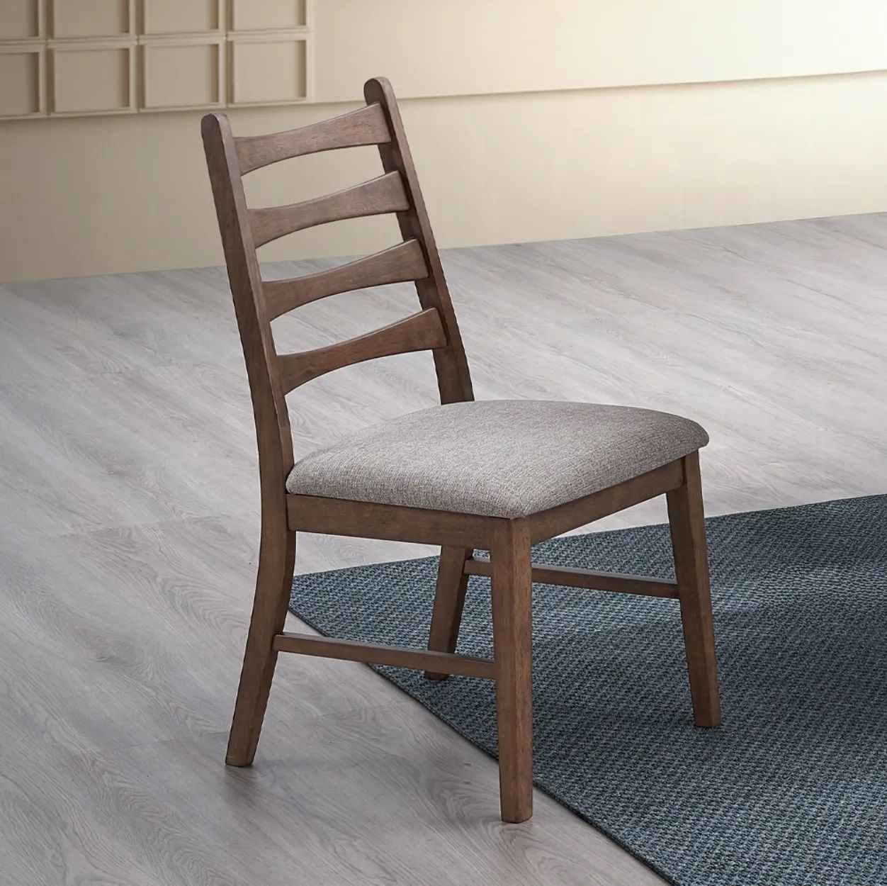A wooden chair is sitting on a rug in a room