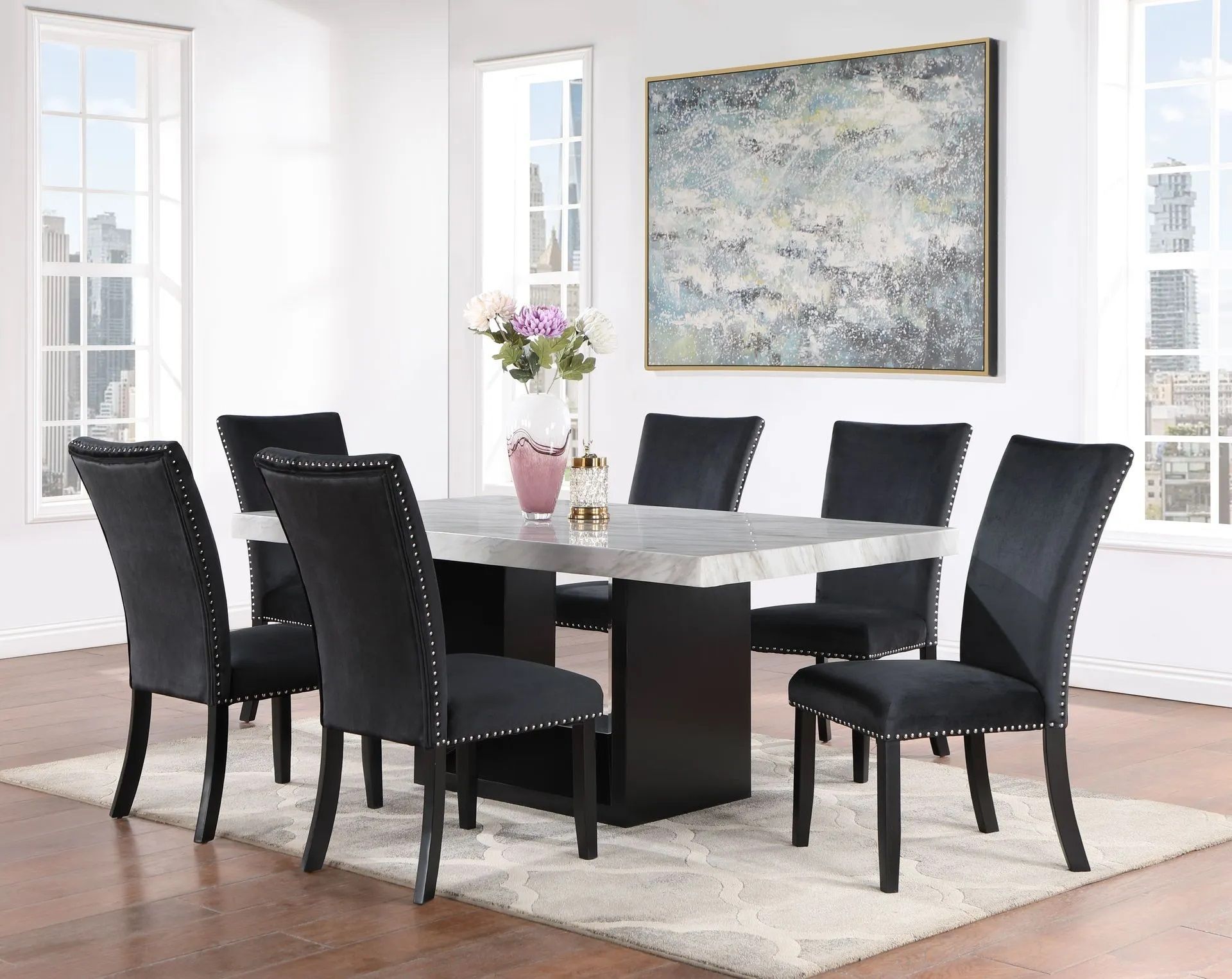 A dining room with a marble table and black chairs