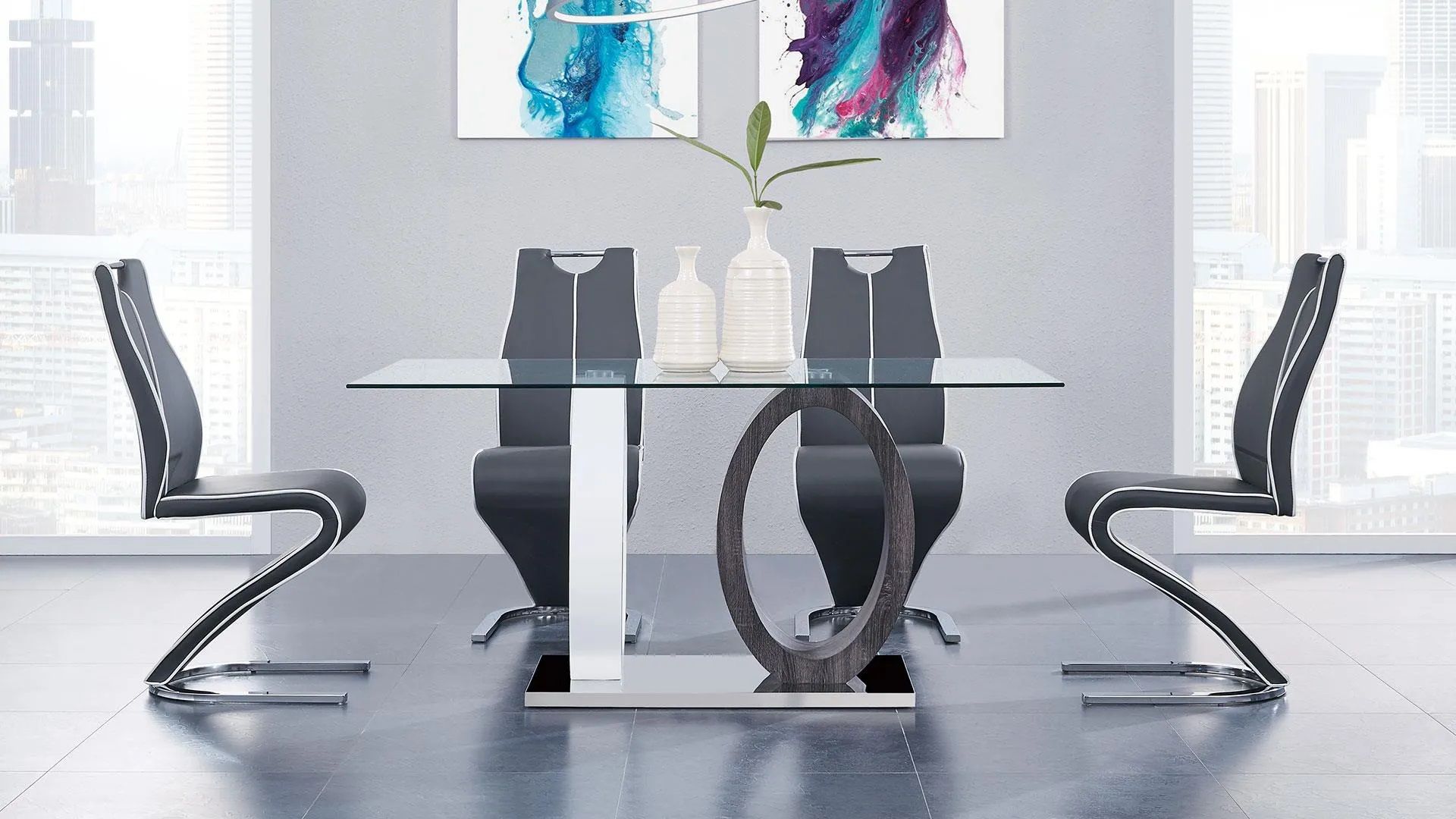 A dining room with a glass table and black chairs.