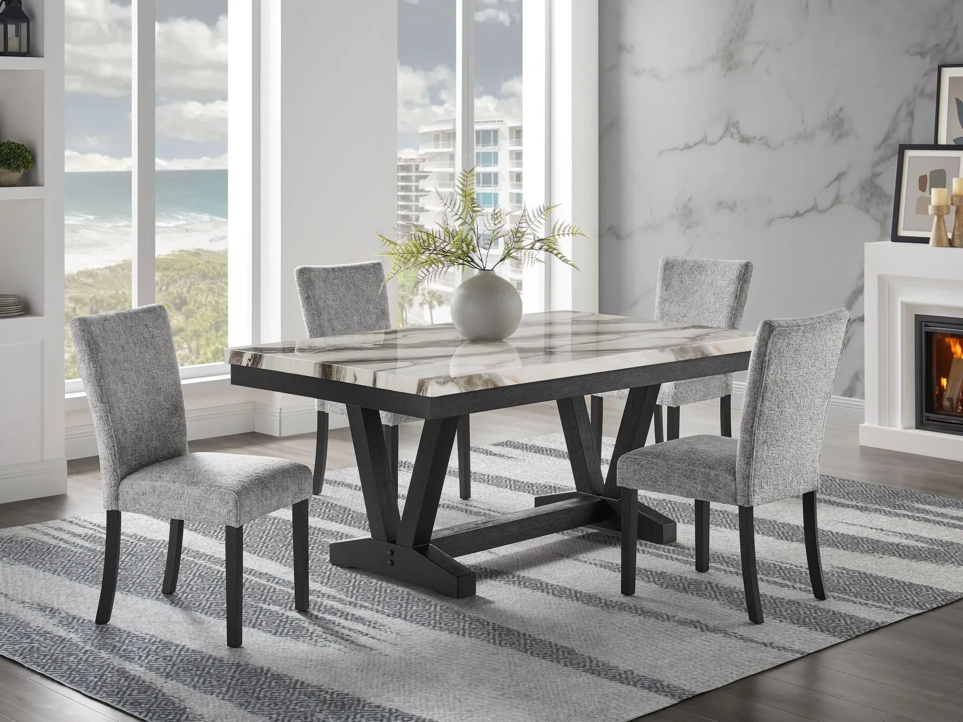 A dining room with a table and chairs and a fireplace.