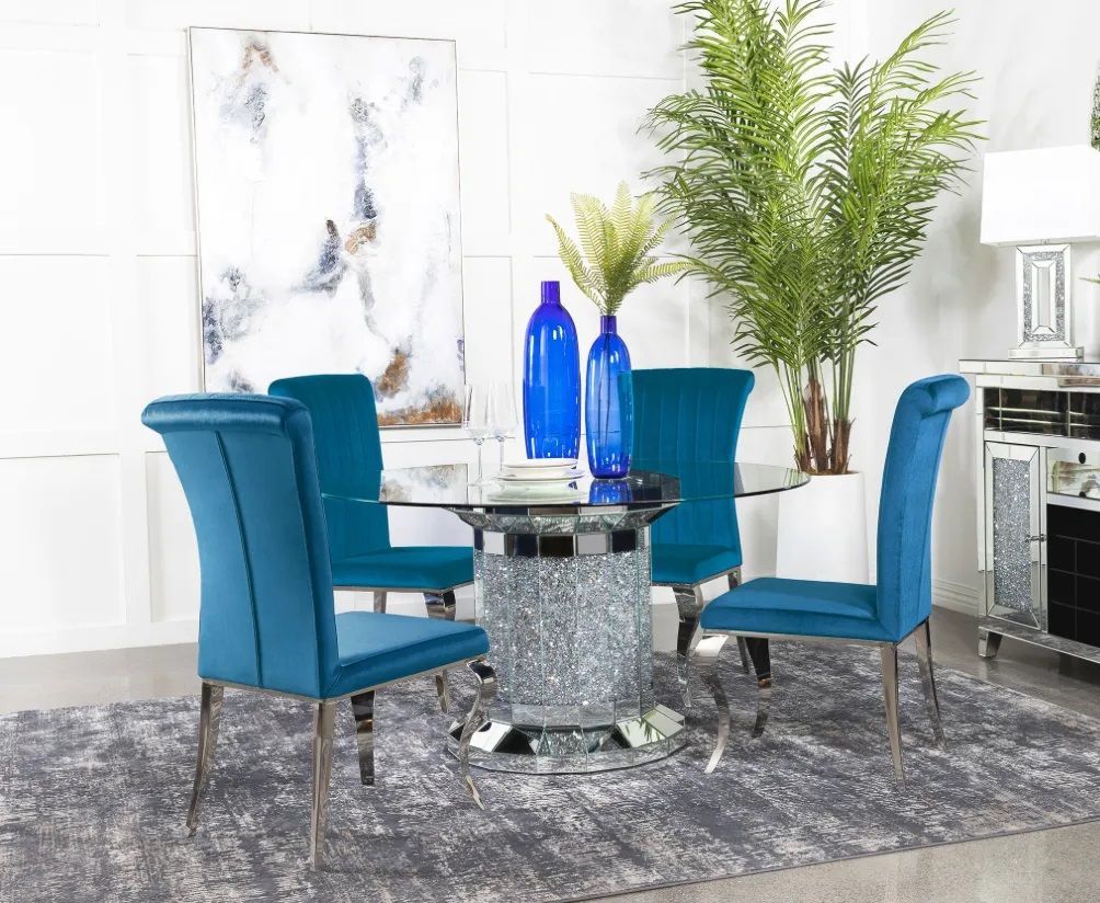 A dining room with a glass table and blue chairs.