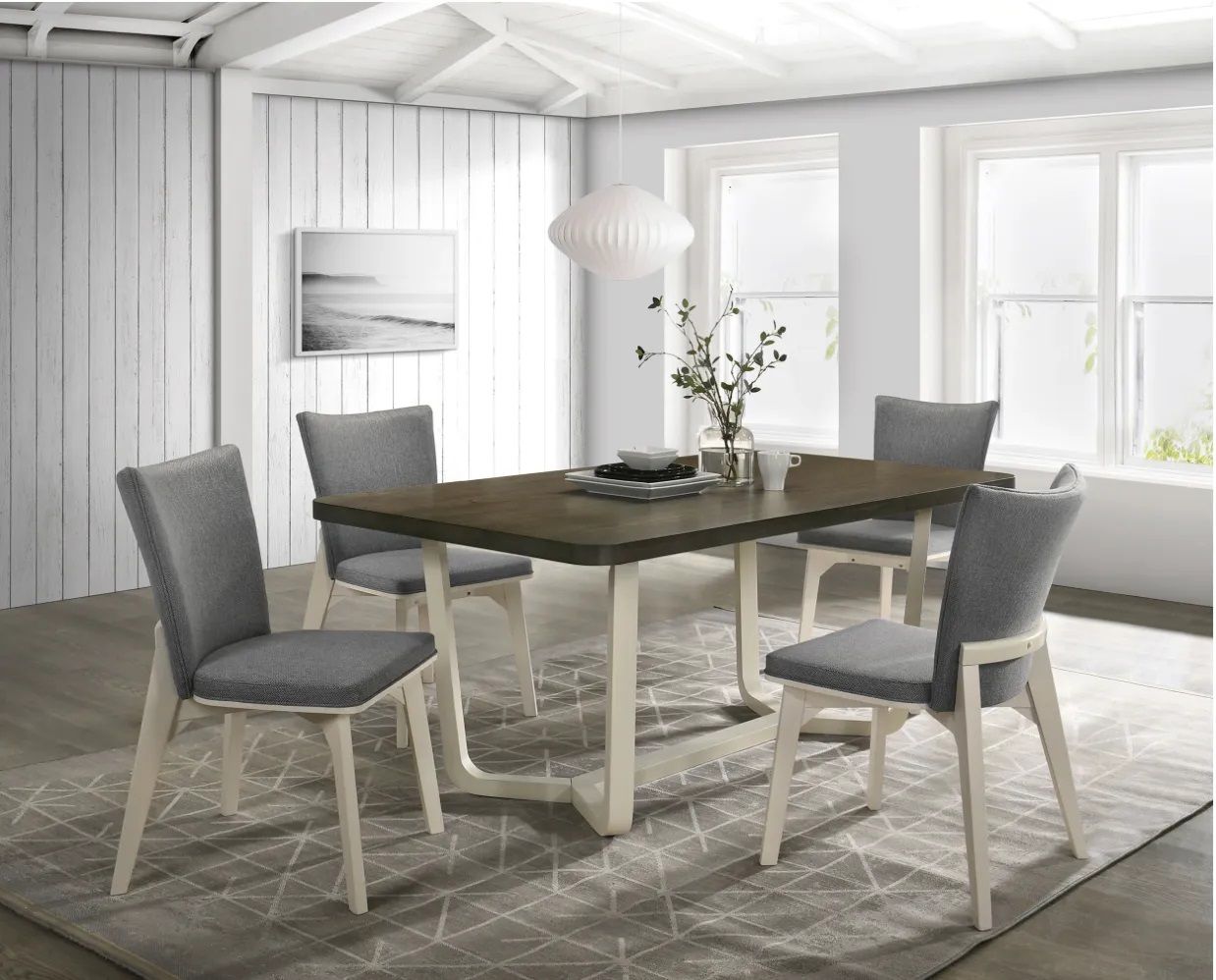 A dining room with a table and chairs and a rug.