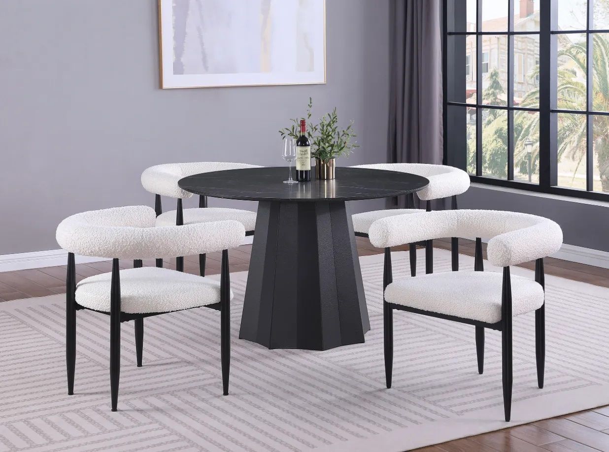 A dining room with a black table and white chairs.