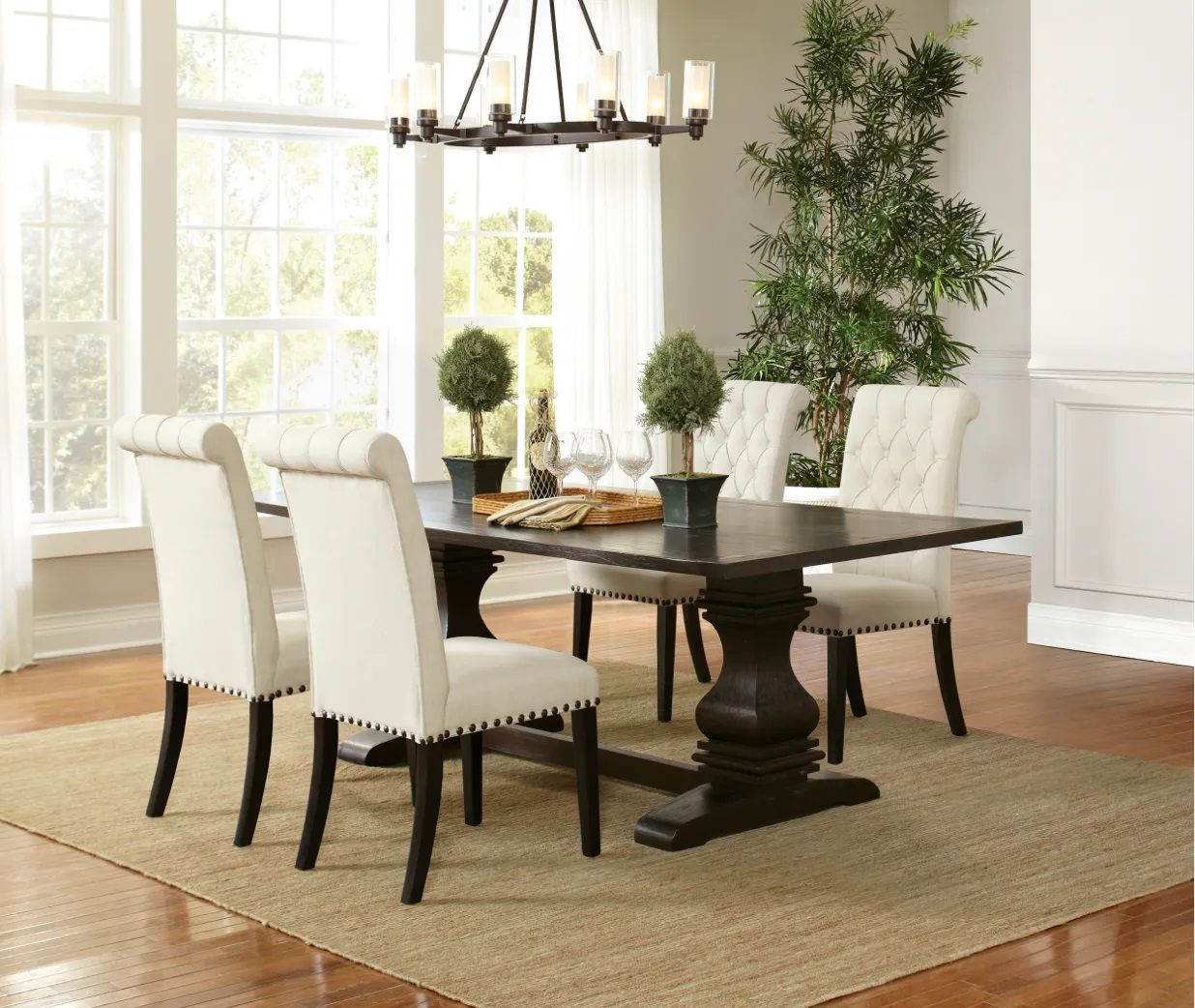 A dining room with a table and chairs and a chandelier