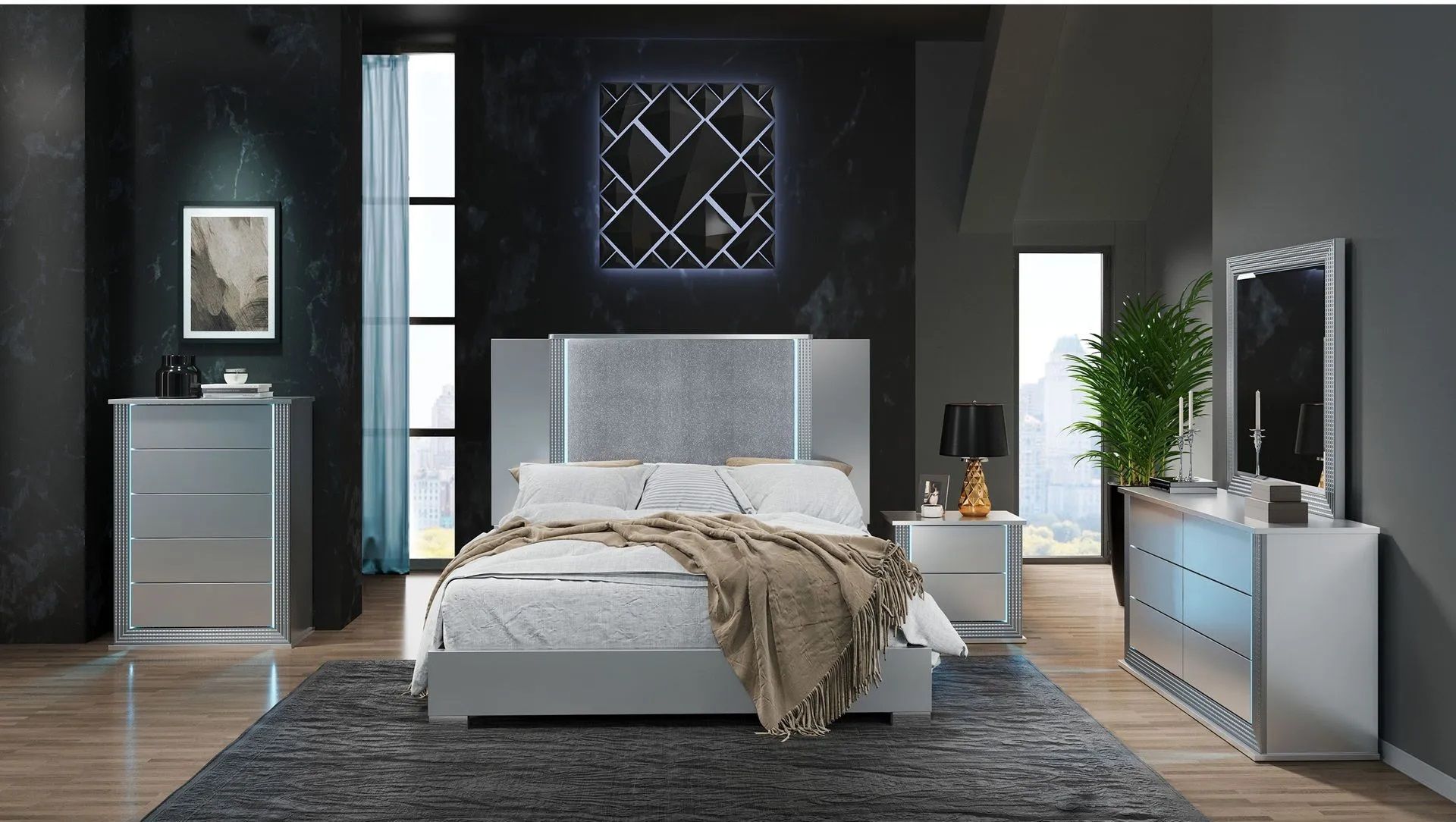 A bedroom with a bed , dresser , nightstand and mirror.