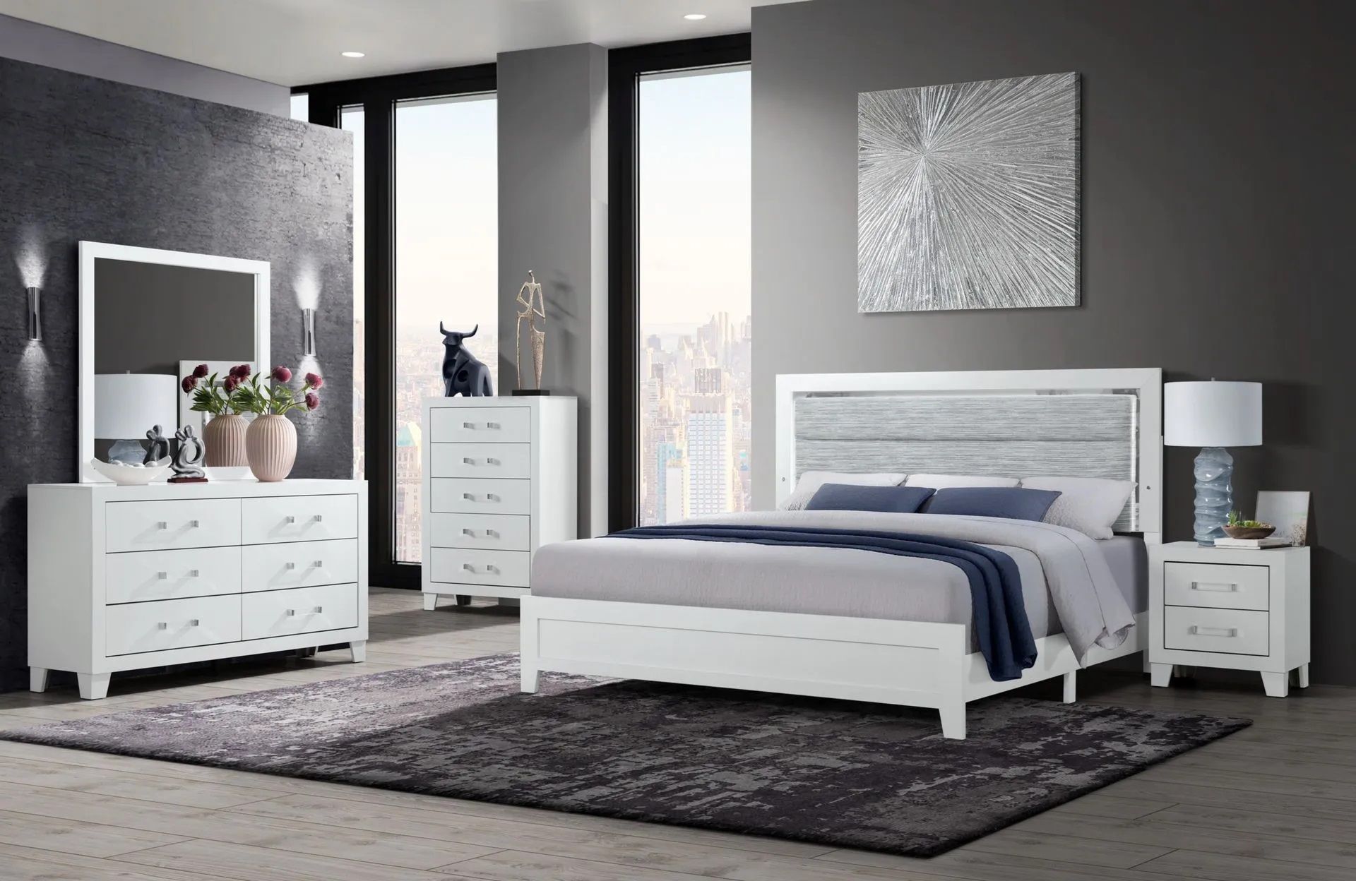 A bedroom with a bed , dresser , nightstand and mirror